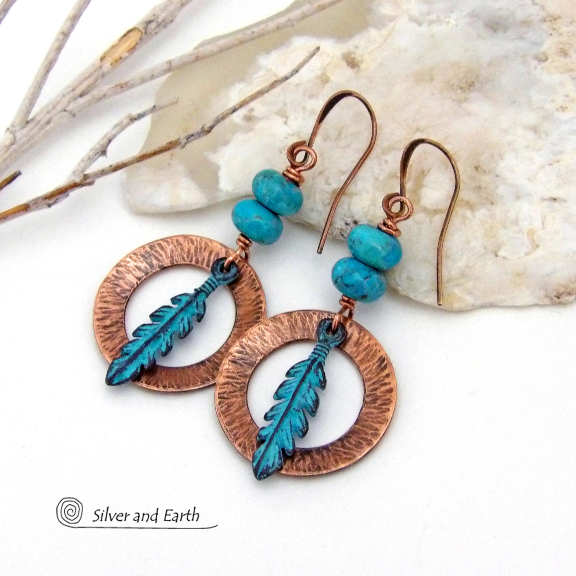 These handcrafted earrings feature round copper hoops with a hammered texture accented with a stack of turquoise beads and patina blue verdigris feathers. Lightweight and comfortable to wear - they'll add a touch of boho southwestern style to your wardrobe. Handmade in the USA by Silver and Earth Jewelry. 