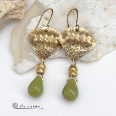 Bold and unique, these handcrafted earrings have an exotic bohemian style with a touch of Egyptian flair. They feature gold brass with a hammered and stamped texture accented with teardrop-shaped natural green jade gemstones and brass beads. Perfect for women that love to wear unique artisan handcrafted jewelry. Total length of approximately 2-3/8" from top of brass ear wires and 1" at widest point. Handmade in the USA by Silver and Earth Jewelry. 