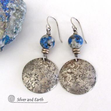 These handcrafted earrings feature sterling silver dangles with an organic hammered texture accented with K2 granite gemstones. It's a unique, interesting stone with beautiful blue azurite inclusions within a black and white speckled granite base. This stone was discovered in the foothills of world's second highest mountain, Mount K2, which it's name is derived from. It's a mixture of granite which includes quartz, feldspar, and mica with blue azurite.