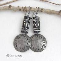 These silver pewter earrings have a rustic, hammered and hand stamped texture and are accented with handmade African tube-shaped beads with a striking black and white pattern. Bold and striking, they'll make a ethnic tribal statement. Perfect for women that unique and one of a kind artisan handcrafted jewelry. Handmade in the USA by Silver and Earth Jewelry.