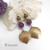 These handcrafted gold brass earrings have a hammered raw silk texture and are accented with natural purple amethyst gemstones, tiny brass beads and tulip flower-shaped brass beads. They have a modern elegant chic style that coordinates beautifully with all wardrobe types - dressed up or down. Makes a great gift for someone with a February birthday - amethyst is that month's birthstone. Handmade in the USA by Silver and Earth Jewelry. 
