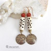 These handcrafted earrings feature a carved African bone beads, red jasper gemstones and textured gold brass dangles. Unique and striking, they have a boho chic style with lots of tribal flair. Perfect for women that love to wear bold unique artisan handmade jewelry. Handmade in the USA by Silver and Earth Jewelry. 