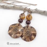 These earrings feature hand-forged bronze metal dangles accented with natural jasper stones and bronze glass beads. They have an earthy, modern boho feel that makes a striking statement. Perfect for women that love unique artisan handcrafted jewelry, earthy hammered textures and natural stones. Handmade in the USA by Silver and Earth Jewelry.