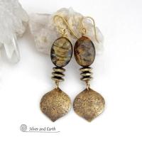 These handcrafted earrings feature gold brass dangles with a hammered organic texture accented with natural brown mica gemstones and faceted hematite stones with an electroplated champagne gold finish. The stones have a beautiful brown hue with undertones of shimmery gold and a faceted finish which casts off a natural sparkle and shine. They have a modern, chic and elegant style that coordinates beautifully with all wardrobe types - dressed up or down.