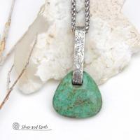 This one-of-a-kind pendant necklace features a beautiful chunky natural chrysocolla gemstone with a faceted finish. The stone is a beautiful shade of bluish-green which resembles turquoise. It hangs from a hand forged solid sterling silver bail with a lightly hammered organic texture. It's reversible. Unique and one-of-a-kind, it's sure to make a statement. Handmade in the USA by Silver and Earth Jewelry.