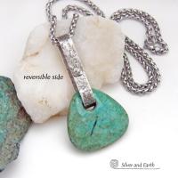 This one-of-a-kind pendant necklace features a beautiful chunky natural chrysocolla gemstone with a faceted finish. The stone is a beautiful shade of bluish-green which resembles turquoise. It hangs from a hand forged solid sterling silver bail with a lightly hammered organic texture. It's reversible. Unique and one-of-a-kind, it's sure to make a statement. Handmade in the USA by Silver and Earth Jewelry.