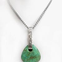 This one-of-a-kind pendant necklace features a beautiful chunky natural chrysocolla gemstone with a faceted finish. The stone is a beautiful shade of bluish-green which resembles turquoise. It hangs from a hand forged solid sterling silver bail with a lightly hammered organic texture. The pendant is reversible. (See all photos for alternate sides). Unique and one-of-a-kind, it's sure to make a statement. Makes a great gift for a natural stone lover - or a nice addition to your own jewelry wardrobe. Handmade