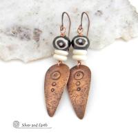 These handcrafted copper earrings have a lightly hammered and hand stamped texture and are accented with patterned African batik bone and off-white bone beads. Bold and striking, they have an ethnic tribal vibe and will make a unique statement. Your choice of ear wire - copper or hypoallergenic niobium. Handmade in the USA by Silver and Earth Jewelry.