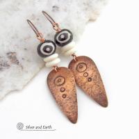 These handcrafted copper earrings have a lightly hammered and hand stamped texture and are accented with patterned African batik bone and off-white bone beads. Bold and striking, they have an ethnic tribal vibe and will make a unique statement. Your choice of ear wire - copper or hypoallergenic niobium. Handmade in the USA by Silver and Earth Jewelry.