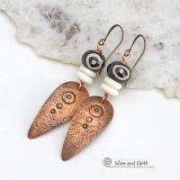 These handcrafted copper earrings have a lightly hammered and hand stamped texture and are accented with patterned African batik bone and off-white bone beads. Bold and striking, they have an ethnic tribal vibe and will make a unique statement. Your choice of ear wire - copper or hypoallergenic niobium. Handmade in the USA by Silver and Earth Jewelry.