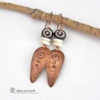 These handcrafted copper earrings have a lightly hammered and hand stamped texture and are accented with patterned African batik bone and off-white bone beads. Bold and striking, they have an ethnic tribal vibe and will make a unique statement. Your choice of ear wire - copper or hypoallergenic niobium. Handmade in the USA by Silver and Earth Jewelry.