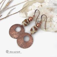 These handcrafted copper earrings have a bold, ethnic African style and flair. They feature round copper dangles with a rustic hammered texture accented with African etched giraffe print agate stones topped off with solid copper beads. Unique and striking, they'll make a bold statement. Perfect for women that love ethnic tribal style jewelry. Handmade in the USA by Silver and Earth Jewelry. 