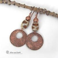 These handcrafted copper earrings have a bold, ethnic African style and flair. They feature round copper dangles with a rustic hammered texture accented with African etched giraffe print agate stones topped off with solid copper beads. Unique and striking, they'll make a bold statement. Perfect for women that love ethnic tribal style jewelry. Handmade in the USA by Silver and Earth Jewelry. 