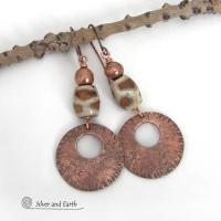 These handcrafted copper earrings have a bold, ethnic African style and flair. They feature round copper dangles with a rustic hammered texture accented with African etched giraffe print agate stones topped off with solid copper beads. Unique and striking, they'll make a bold statement. Perfect for women that love ethnic tribal style jewelry. Handmade in the USA by Silver and Earth Jewelry. 