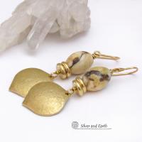 These handcrafted earrings feature shiny gold brass dangles with a hammered raw silk texture accented with graphic feldspar gemstones and shiny brass beads. Graphic feldspar is a type of moonstone that has smoky quartz inclusions which creates unique natural patterns. They have an elegant, modern chic style that looks great dressed up or down. 