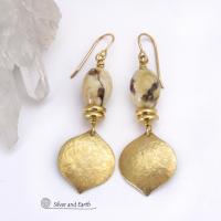 These handcrafted earrings feature shiny gold brass dangles with a hammered raw silk texture accented with graphic feldspar gemstones and shiny brass beads. Graphic feldspar is a type of moonstone that has smoky quartz inclusions which creates unique natural patterns. They have an elegant, modern chic style that looks great dressed up or down. 