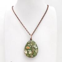 This pendant necklace is perfect for those that prefer a modern, simplistic and earthy style. It features a natural green rainforest jasper gemstone wrapped in copper wire on a textured and oxidized copper chain necklace. The stone has a beautiful natural matrix pattern in earthy hues of green with orbs of white inclusions and a touch of orange. 