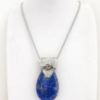 This sterling silver necklace features a natural lapis lazuli gemstone accented with a handcrafted sterling silver bail with a lightly hammered organic texture. The lapis is a beautiful shade of blue with natural sparkly pyrite inclusions.
