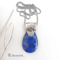 This sterling silver necklace features a natural lapis lazuli gemstone accented with a handcrafted sterling silver bail with a lightly hammered organic texture. The lapis is a beautiful shade of blue with natural sparkly pyrite inclusions.