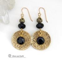 These handcrafted earrings feature gold brass dangles with a hand stamped texture accented with round black onyx gemstones dangling in front and topped off with black onyx gemstones and tulip flower-shaped beads. They have a modern, elegant chic style that looks great dressed up or down. Perfect for women that love bold unique artisan handcrafted jewelry. They'll make a great wife gift for couples celebrating their 7th anniversary - onyx is the gemstone for this occasion. USA Handmade by Silver and Earth. 