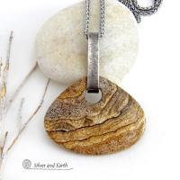 This handcrafted necklace features a large, chunky natural picture jasper stone accented with a handcrafted sterling silver bail. The stone has a beautiful natural pattern in various shades of brown, beige and gray. Big and bold, this necklace is a real one-of-a-kind statement piece - perfect for anyone that loves natural stones! It's reversible and can be worn on either side. Coordinating earrings sold separately. Handmade in the USA by Silver and Earth Jewelry.