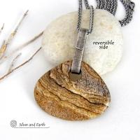 This handcrafted necklace features a large, chunky natural picture jasper stone accented with a handcrafted sterling silver bail. The stone has a beautiful natural pattern in various shades of brown, beige and gray. Big and bold, this necklace is a real one-of-a-kind statement piece - perfect for anyone that loves natural stones! It's reversible and can be worn on either side. Coordinating earrings sold separately. Handmade in the USA by Silver and Earth Jewelry.