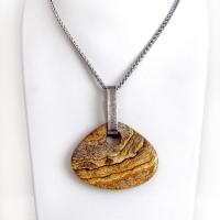 This handcrafted necklace features a large, chunky natural picture jasper stone accented with a handcrafted sterling silver bail. The stone has a beautiful natural pattern in various shades of brown, beige and gray. Big and bold, this necklace is a real one-of-a-kind statement piece - perfect for anyone that loves natural stones! It's reversible and can be worn on either side. Coordinating earrings sold separately. Handmade in the USA by Silver and Earth Jewelry.