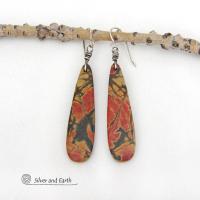 Full of earthy charm - these one-of-a-kind earrings feature long natural red creek jasper stones dangling from sterling silver ear wires. The stones have a beautiful natural pattern in earthy hues of mossy greens, brick red, orange and subtle hints of golden yellow. They'll make a great gift for anyone that loves natural stones!