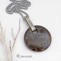 This one-of-a-kind necklace features a natural stromatolite fossil stone accented with a hand forged sterling silver bail with a lightly hammered organic texture. Stromatolites are fossilized layered deposits of algae within ancient sedimentary rock. These old single-celled organisms are believed to be some of the first forms of life on this planet.