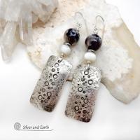 These handcrafted sterling silver earrings have a hand stamped and lightly hammered organic texture and are accented with natural sunstone / moonstone gemstones and mother of pearl and small stainless steel beads. This hybrid stone is rare and found only in Tanzania. It has beautiful shimmery hues of black with natural silvery flashes and subtle peach and gold inclusions. These earrings have a modern, elegant chic style that looks great dressed up or down. Perfect for women that love unique gemstone jewelry