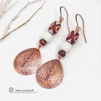 These handmade copper earrings have a hammered and hand stamped texture and are accented with Tibetan etched agate stones, African glass beads and small brown jasper stones. They have an ethnic, boho chic flair and are fun to wear.