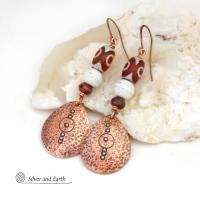 These handmade copper earrings have a hammered and hand stamped texture and are accented with Tibetan etched agate stones, African glass beads and small brown jasper stones. They have an ethnic, boho chic flair and are fun to wear.