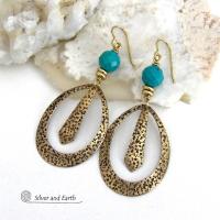 These handcrafted gold brass hoop earrings have a hand stamped texture and are accented with beautiful genuine turquoise gemstones with a faceted finish and small brass beads. They have an exotic boho chic design with an Egyptian inspired vibe and flair. Suitable for any occasion - they'll look great dressed up or down. Perfect for women that love to wear artisan handcrafted jewelry that makes a bold statement. Earrings are lightweight and comfortable to wear. Handmade in the USA by Silver and Earth Jewelry