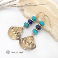 These handcrafted gold brass earrings have a unique hand textured design and are accented with a stack of blue lapis lazuli and turquoise gemstones separated with small brass beads. They have a modern style with a boho chic flair that will make a unique statement.