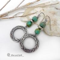 These handcrafted earrings feature silver pewter hoops with a hand stamped texture accented with natural, genuine turquoise stones and silver plated beads. Lightweight and comfortable to wear, they have an earthy modern style with southwest flair that coordinates beautifully with all wardrobe types. Handmade in the USA by Silver and Earth Jewelry, a Certified New Mexico True business.