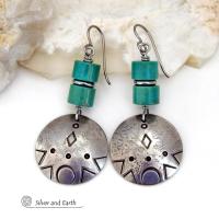 These handcrafted earrings feature silver pewter dangles with a hand stamped texture accented with natural turquoise stones and stainless steel spacer beads. They have a bold modern style with southwestern flair and will make a unique striking statement. They'll make a great gift for anyone that loves turquoise stones and southwest style jewelry. Handmade in the USA by Silver and Earth Jewelry.