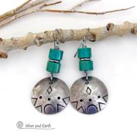 These handcrafted earrings feature silver pewter dangles with a hand stamped texture accented with natural turquoise stones and stainless steel spacer beads. They have a bold modern style with southwestern flair and will make a unique striking statement. They'll make a great gift for anyone that loves turquoise stones and southwest style jewelry. Handmade in the USA by Silver and Earth Jewelry.