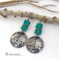 These handcrafted earrings feature silver pewter dangles with a hand stamped texture accented with natural turquoise stones and stainless steel spacer beads. They have a bold modern style with southwestern flair and will make a unique striking statement. They'll make a great gift for anyone that loves turquoise stones and southwest style jewelry. Handmade in the USA by Silver and Earth Jewelry.