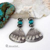 These handcrafted sterling silver earrings feature a unique hand textured design and are accented with natural turquoise and metallic gray pyrite stones. They have a southwestern boho tribal flair and will make a striking statement. The pyrite stones add a touch of natural sparkle and shine. Handmade in the USA by Silver and Earth Jewelry. 