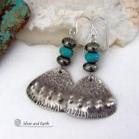 These handcrafted sterling silver earrings feature a unique hand textured design and are accented with natural turquoise and metallic gray pyrite stones. They have a southwestern boho tribal flair and will make a striking statement. The pyrite stones add a touch of natural sparkle and shine. Handmade in the USA by Silver and Earth Jewelry. 