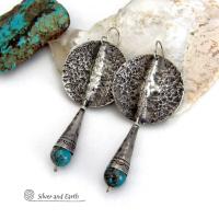 Big and bold - these handcrafted sterling silver earrings have an earthy, organic design with an edgy, modern southwest style. They feature solid sterling silver with a rustic, hammered texture and a dark oxidized finish. They are accented with hammered and hand stamped sterling silver cones and natural turquoise stone beads. Perfect for women that love to wear bold organic looking jewelry with a subtle southwest style and flair. Handmade in USA by Silver and Earth, a New Mexico True Certified Business.