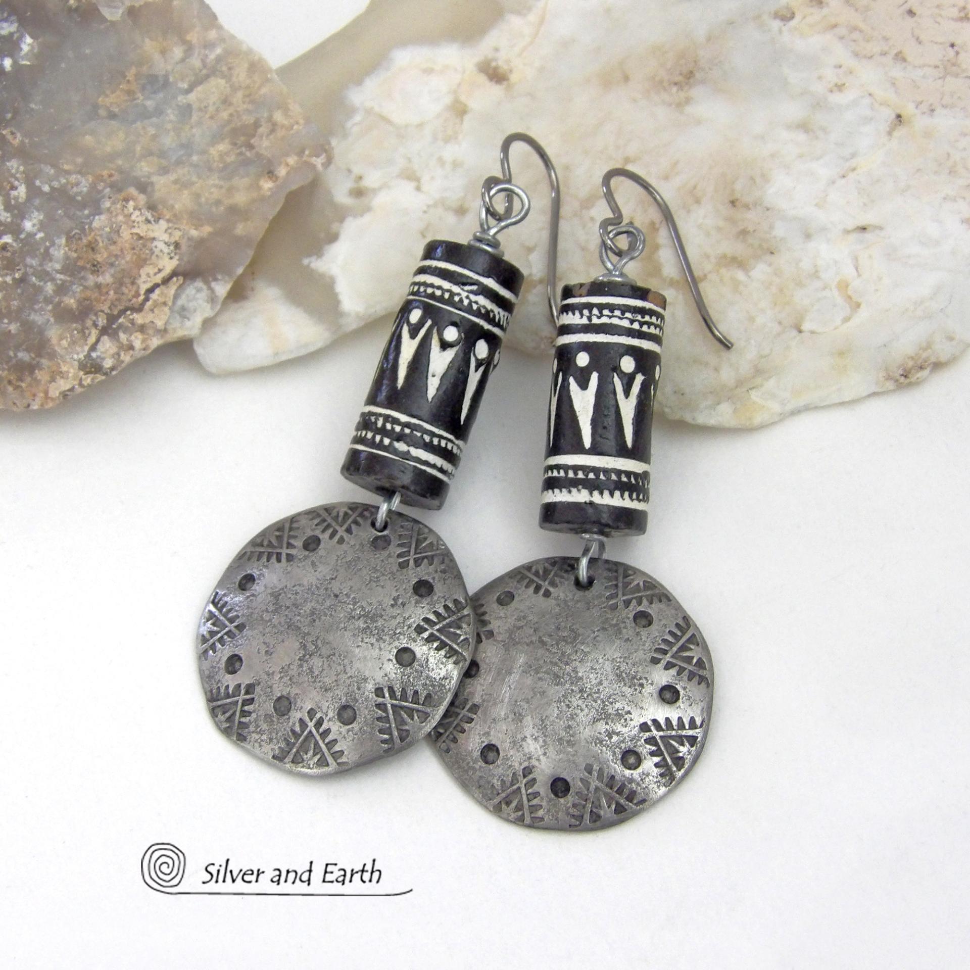 These silver pewter earrings have a rustic, hammered and hand stamped texture and are accented with handmade African tube-shaped beads with a striking black and white pattern. Bold and striking, they'll make a ethnic tribal statement. Perfect for women that unique and one of a kind artisan handcrafted jewelry. Handmade in the USA by Silver and Earth Jewelry.