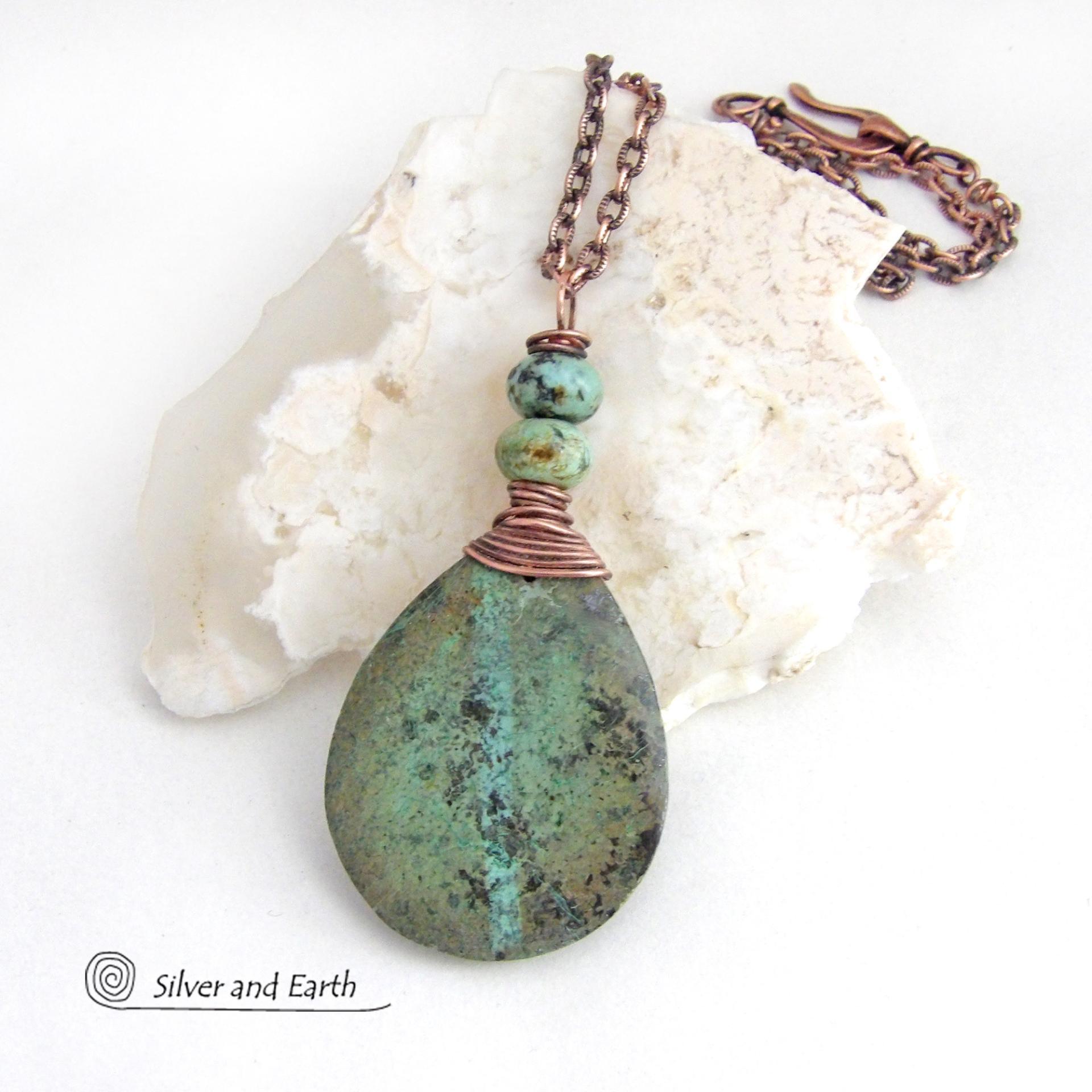This one-of-a-kind necklace features a natural African turquoise stone wrapped in copper wire and accented with African turquoise stone beads. The stone has an earthy, organic feel with hues of dark blue-green, along with a subtle natural black matrix. It will make a great gift for a natural stone lover - or a nice addition to your own jewelry collection. 