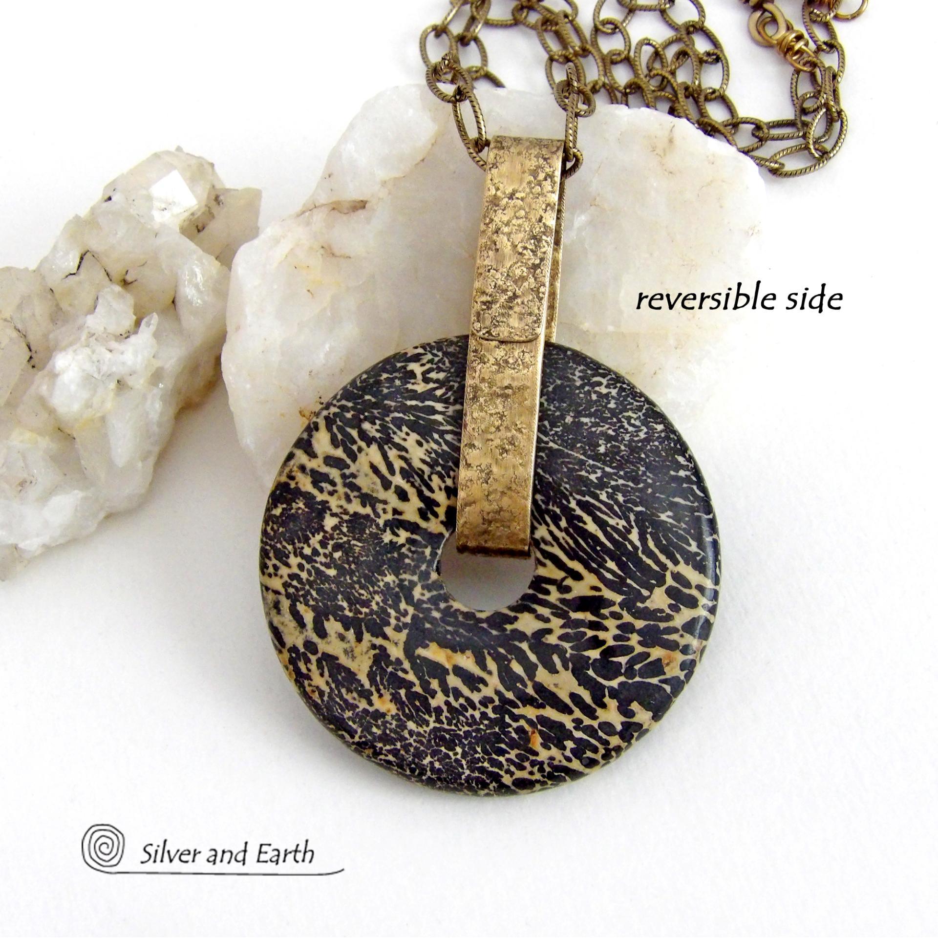 This one-of-a-kind pendant necklace features a stunning artistic jasper stone accented with a hand forged gold brass bail. This type of jasper is known for its intricate, natural patterns that resemble brushstrokes, landscapes, or abstract art. The stone in this piece has a natural bold dramatic pattern in hues of black and soft golden yellow with black streaks that resemble "feathery" dendrites. The design is modern and bold - yet classic and always in fashion. It can be worn by either a man or women. 