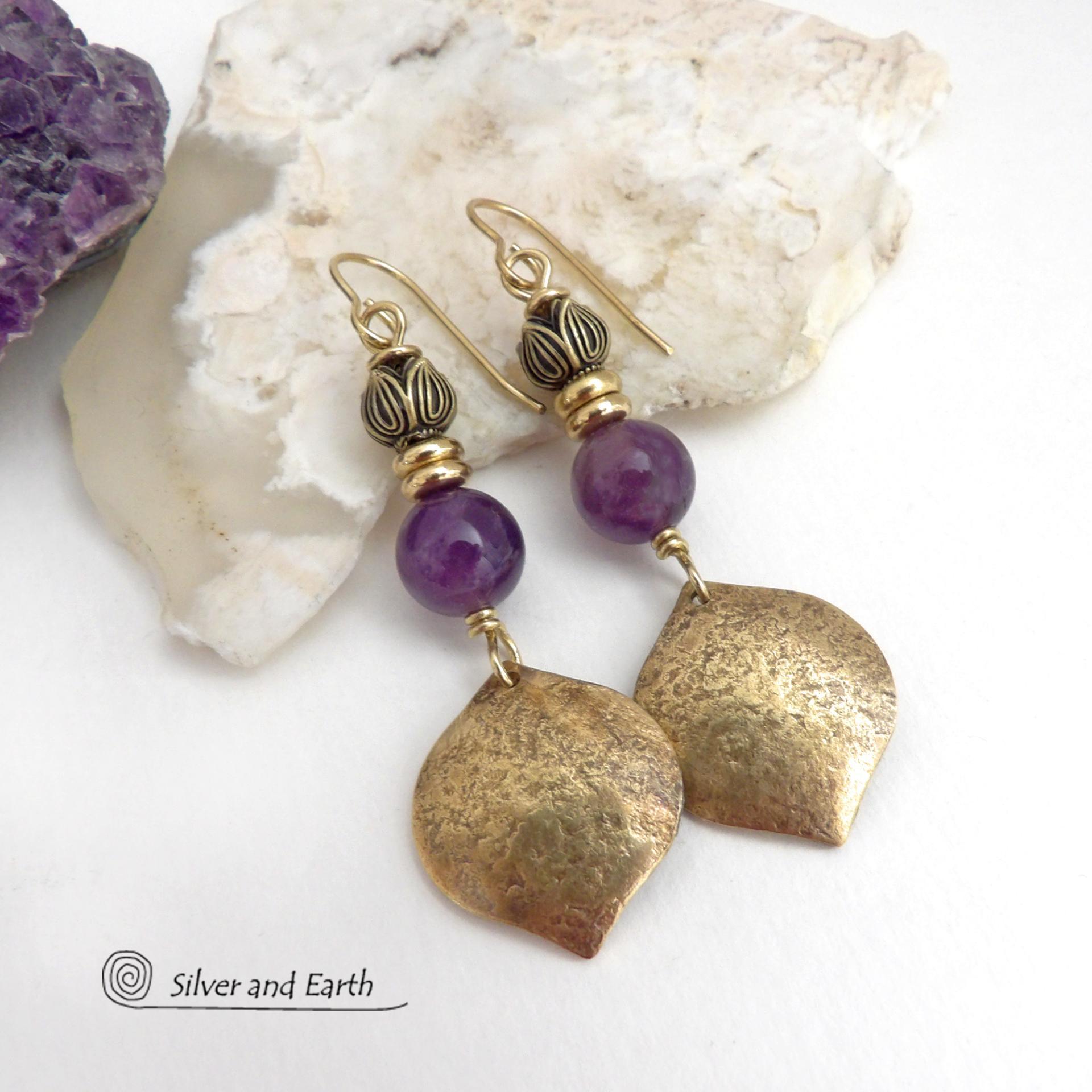 These handcrafted gold brass earrings have a hammered raw silk texture and are accented with natural purple amethyst gemstones, tiny brass beads and tulip flower-shaped brass beads. They have a modern elegant chic style that coordinates beautifully with all wardrobe types - dressed up or down. Makes a great gift for someone with a February birthday - amethyst is that month's birthstone. Handmade in the USA by Silver and Earth Jewelry. 
