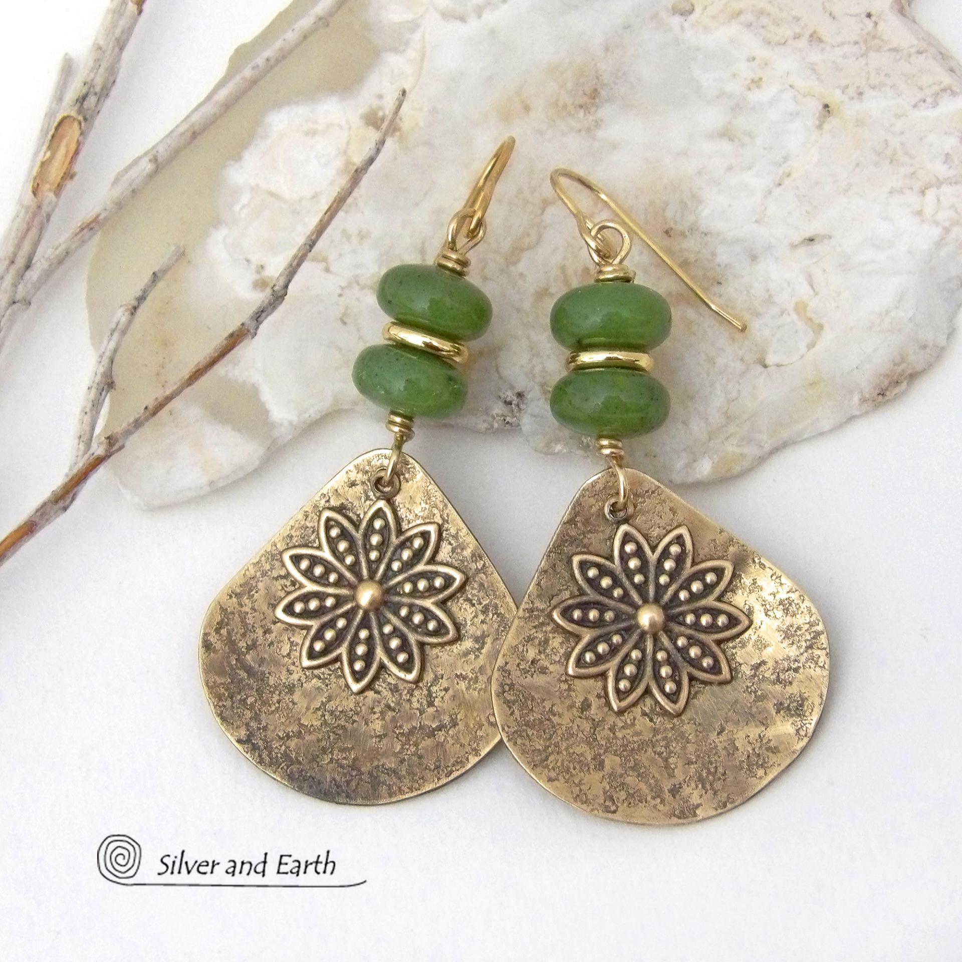 These handcrafted gold brass earrings have an earthy and modern nature-inspired charm. The design consists of brass fan-shaped dangles accented with Canadian green jade gemstones, brass flower charms and brass beads. The flowers have a lovely detailed texture and swing freely in front of the lightly hammered brass dangles. Perfect for your spring / summer wardrobe - or any time of year. They'll make a great gift for a nature and/or flower lover - or a nice addition to your own jewelry wardrobe. 