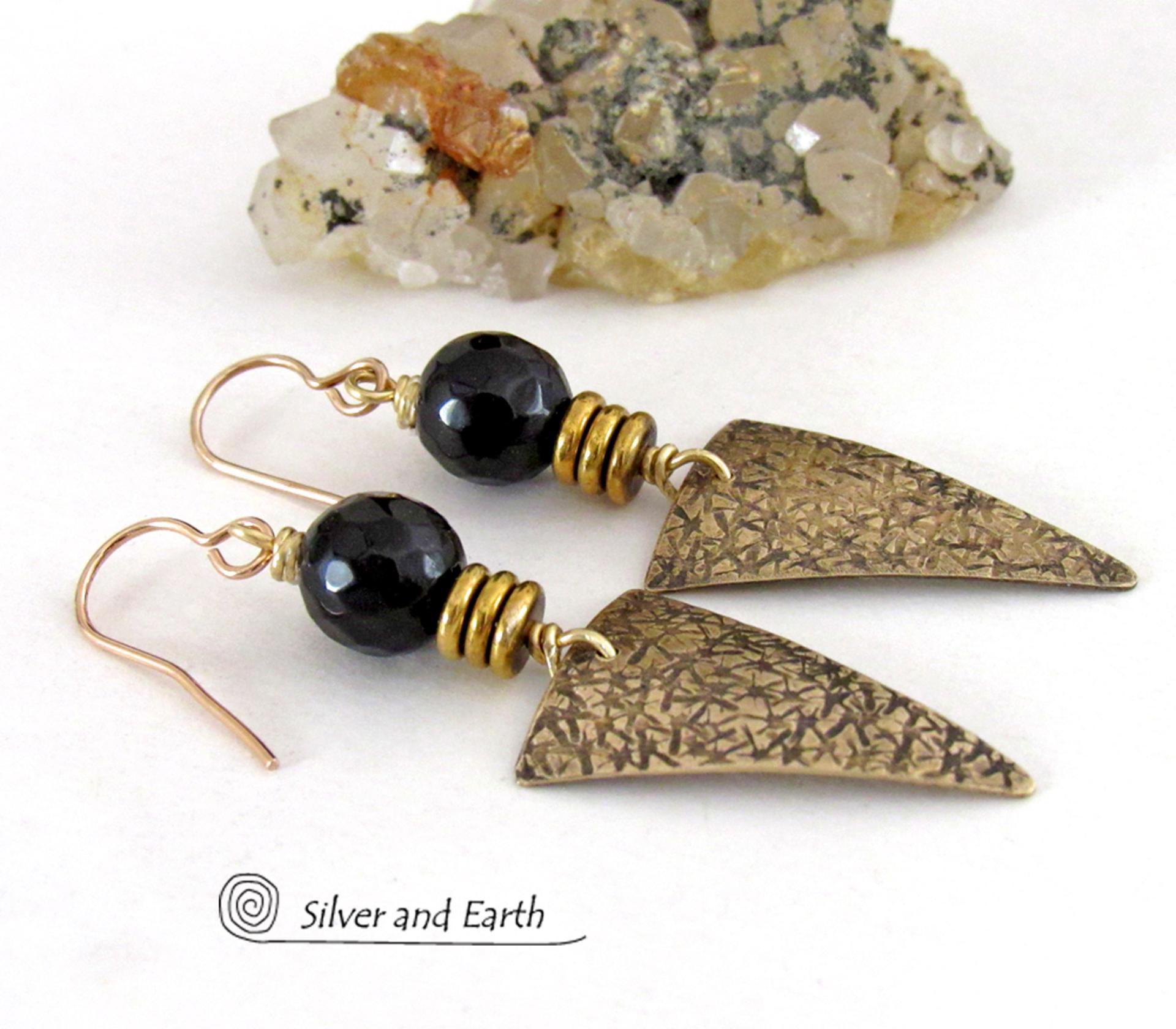 These gold brass triangle earrings have a hand stamped texture and are accented with black onyx gemstones above a stack of tiny brass beads. The stones have a faceted finish which gives off a natural sparkle and shine. Lightweight and comfortable to wear - they have a modern chic contemporary style that coordinates well with all wardrobes types. Handmade in the USA by Silver and Earth Jewelry.