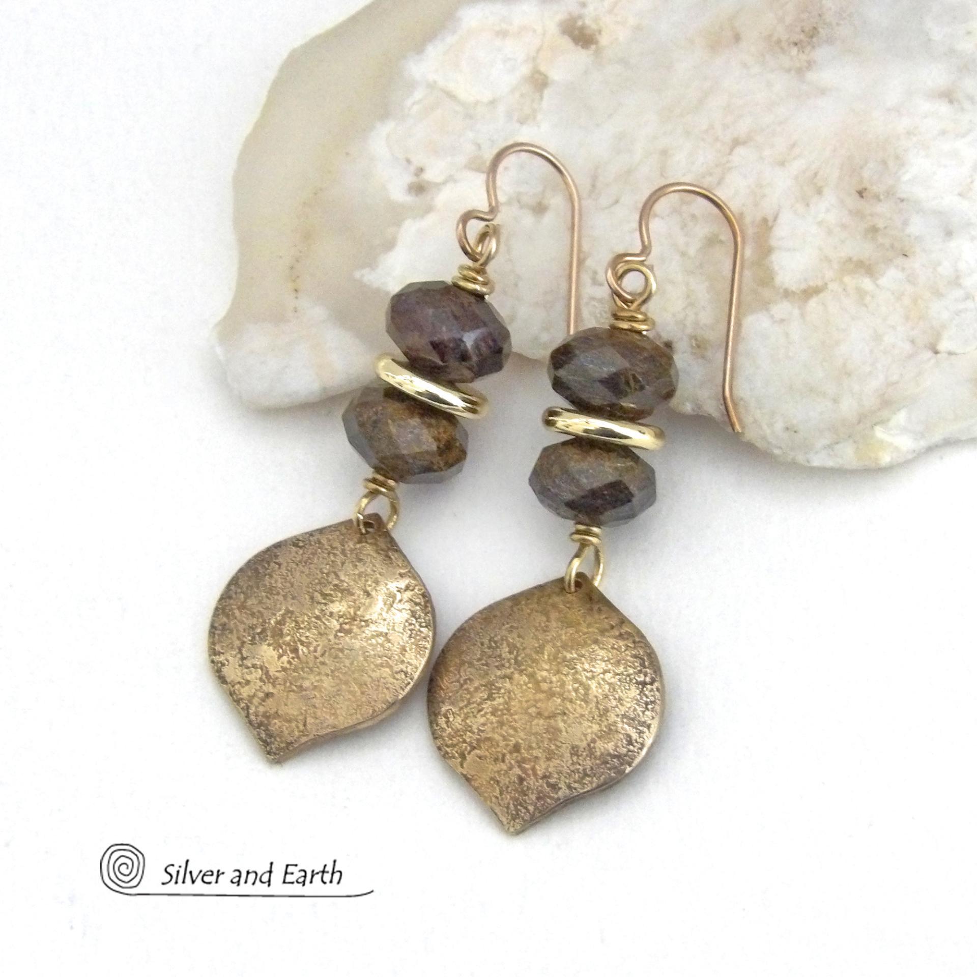 These handcrafted earrings feature gold brass dangles with a hammered organic texture accented with natural bronzite gemstones and shiny gold brass beads. The stones have a beautiful brown hue with a faceted finish which casts off a natural sparkle and shine. They have a modern chic style that coordinates beautifully with all wardrobe types - dressed up or down. A coordinating necklace is available that is sold separately.  Handmade in the USA by Silver and Earth Jewelry.
