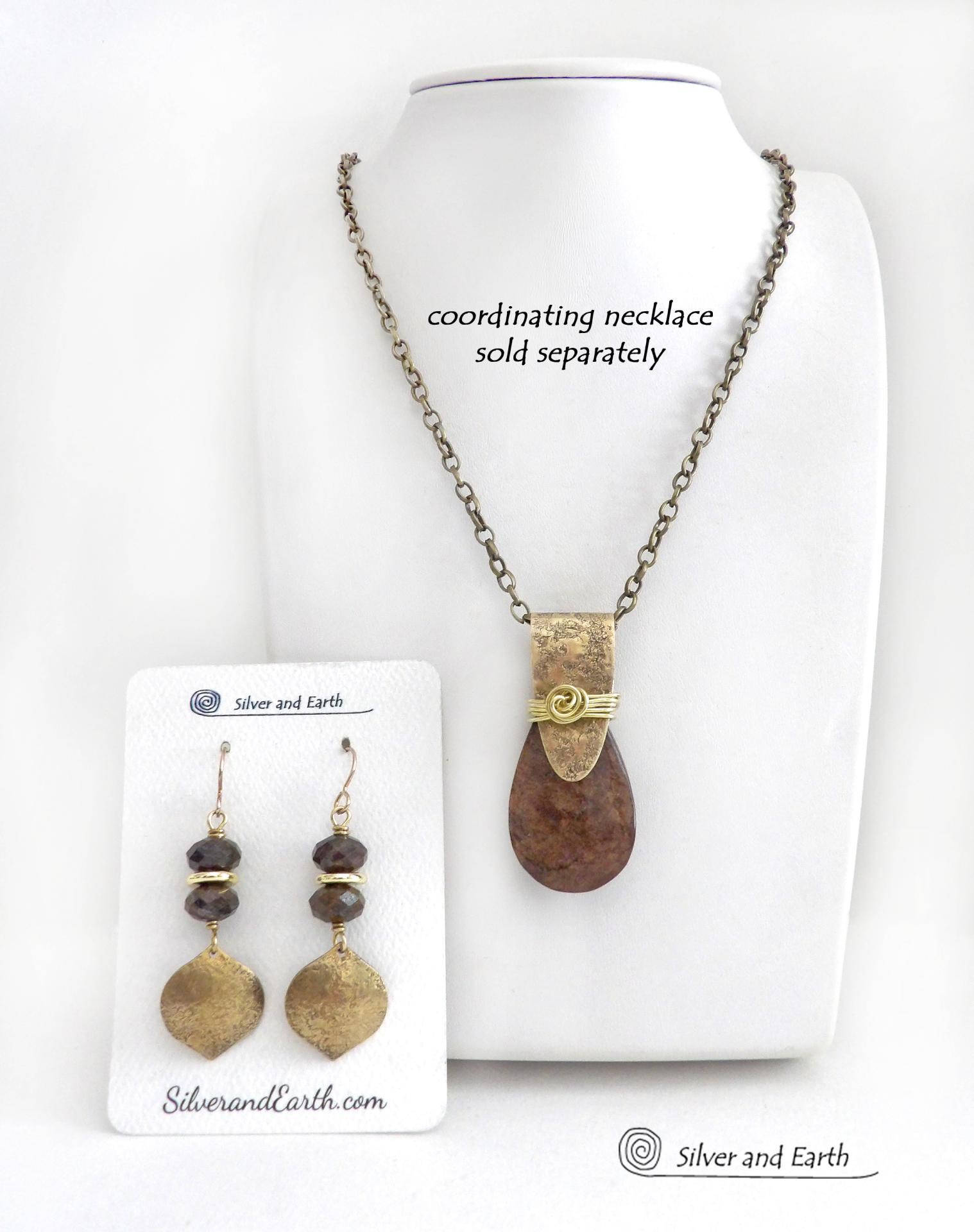 These handcrafted earrings feature gold brass dangles with a hammered organic texture accented with natural bronzite gemstones and shiny gold brass beads. The stones have a beautiful brown hue with a faceted finish which casts off a natural sparkle and shine. They have a modern chic style that coordinates beautifully with all wardrobe types - dressed up or down. A coordinating necklace is available that is sold separately.  Handmade in the USA by Silver and Earth Jewelry.