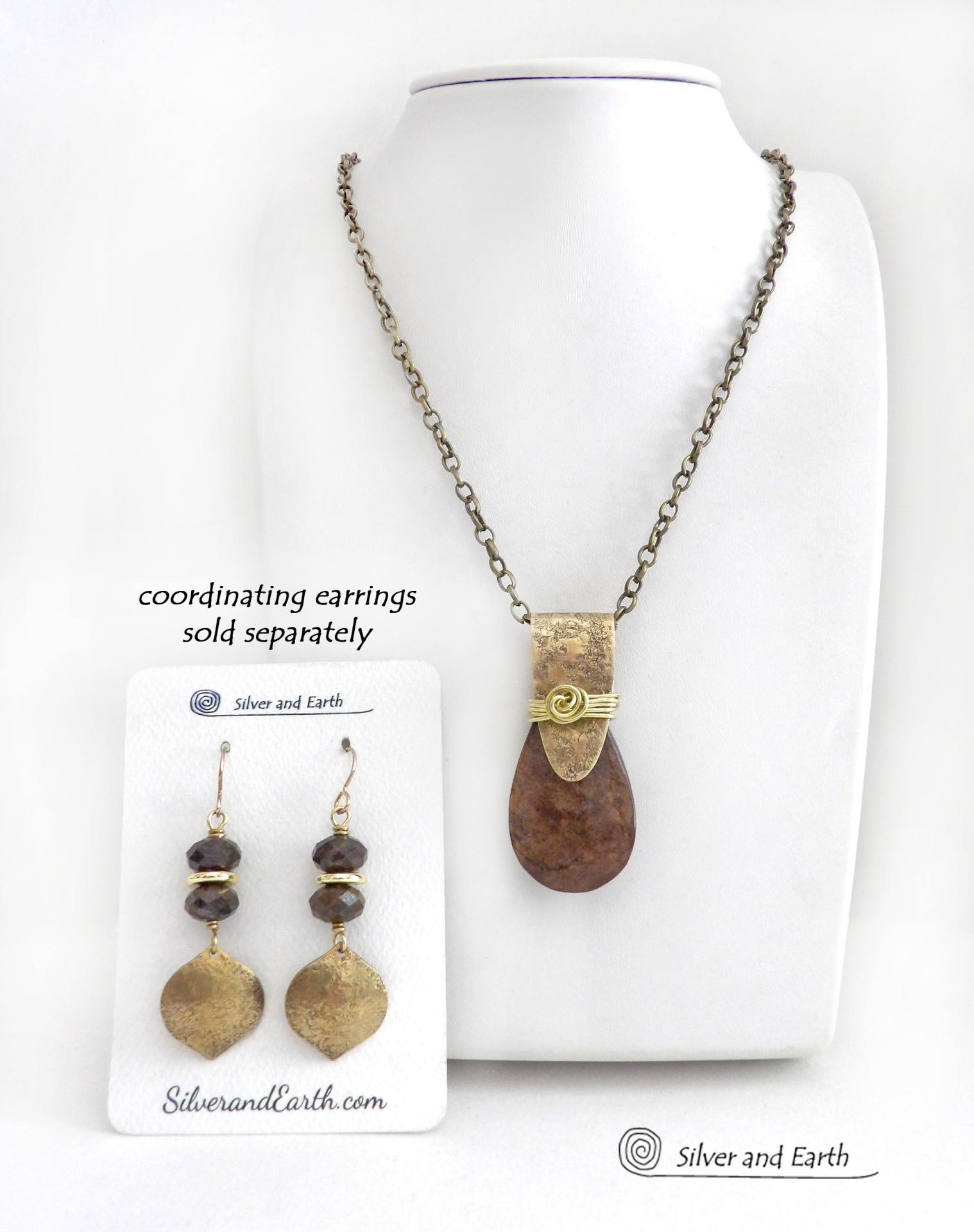 This handcrafted necklace features a natural bronzite gemstone accented with a gold brass bail. The stone has a beautiful chocolate brown hue with a subtle golden shimmer. Bronzite is a mineral that shares characteristics with rock that is found in meteorites, such as iron. It's this blend of several minerals which gives bronzite its unique mottled characteristic. The necklace has an earthy, modern style that coordinates beautifully with all wardrobe types. 